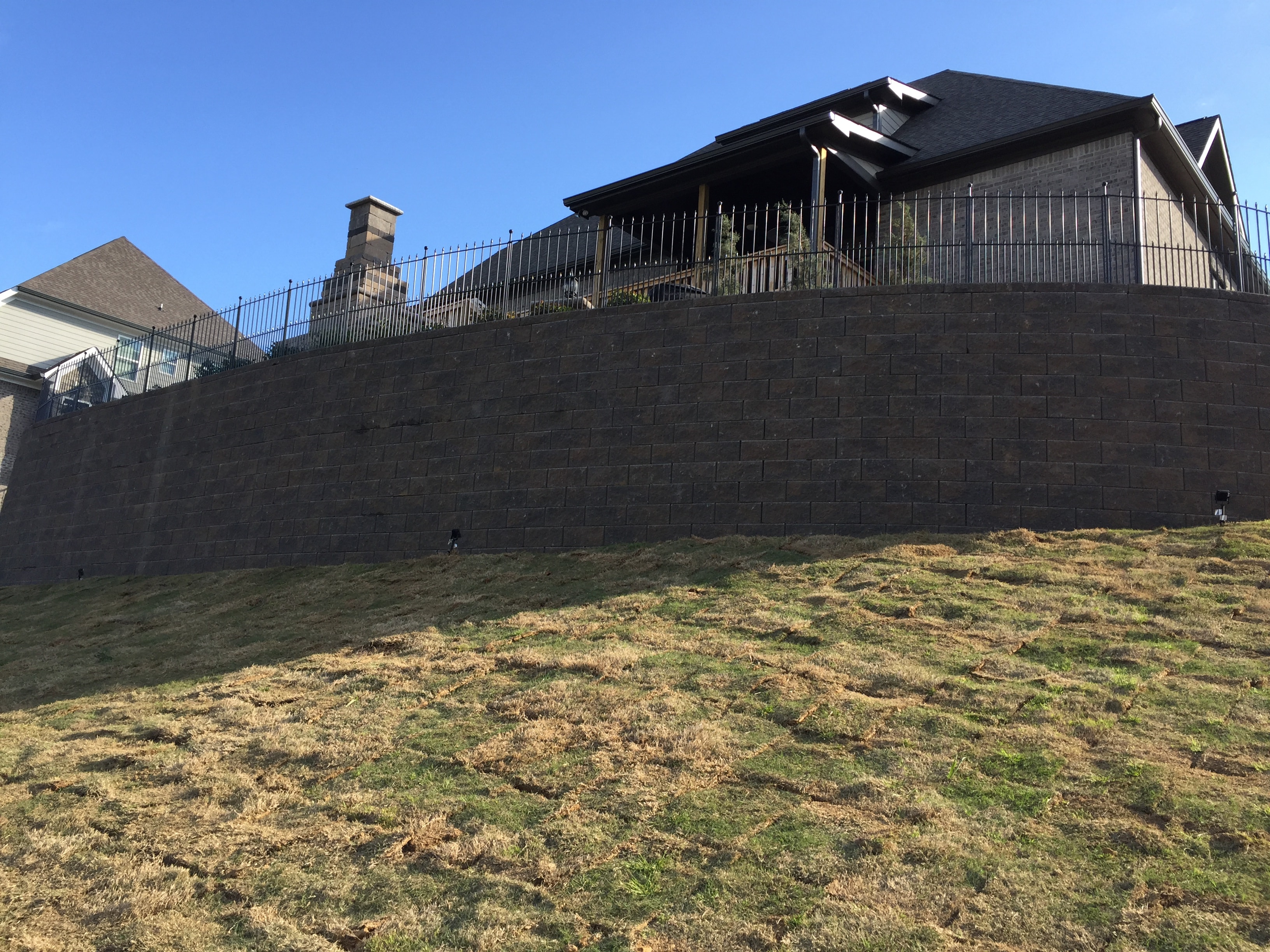 Modern house on hillside with retaining wall